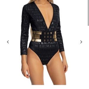 Balmain Embellished Monogram Print One-Piece
Swimsuit
With belt